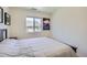 This bedroom features a comfortable bed, a neutral color scheme, and a modern art piece at 7022 Todd Ct, Frederick, CO 80530