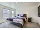 Well-lit bedroom features large windows, comfortable gray carpet, and a dark nightstand at 7022 Todd Ct, Frederick, CO 80530