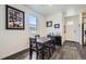 Cozy dining area with a wooden table and chairs, next to the front door at 7022 Todd Ct, Frederick, CO 80530