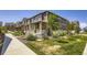 Street view of multiple townhomes with covered porches and landscaped front yards at 7022 Todd Ct, Frederick, CO 80530