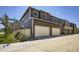 Modern townhome showcasing a two-car garage, contemporary siding, and professional landscaping at 7022 Todd Ct, Frederick, CO 80530