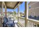 Cozy covered front porch with chairs, offering a relaxing outdoor space at 7022 Todd Ct, Frederick, CO 80530