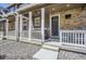 Inviting covered front porch with seating and decorative touches at 7022 Todd Ct, Frederick, CO 80530