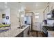 Well-lit kitchen with stainless steel appliances, an island with a sink, and sleek cabinetry at 7022 Todd Ct, Frederick, CO 80530
