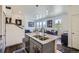 Open kitchen with a large island, modern lighting, and stainless steel appliances at 7022 Todd Ct, Frederick, CO 80530
