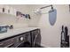 Well-organized laundry room features a washer, dryer, folding counter, and storage shelving at 7022 Todd Ct, Frederick, CO 80530