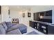 Cozy living room with a gray sectional, television, and contemporary decor at 7022 Todd Ct, Frederick, CO 80530