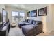 Comfortable living room featuring a large sectional sofa, modern art, and natural light at 7022 Todd Ct, Frederick, CO 80530