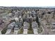 Scenic aerial view of a residential neighborhood featuring tree-lined streets and diverse home styles under a blue sky at 464 Chiswick Cir, Highlands Ranch, CO 80126