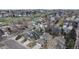 Wide aerial shot showcasing a neighborhood with well-maintained homes, green spaces, and tree coverage at 464 Chiswick Cir, Highlands Ranch, CO 80126