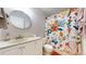 Well-maintained bathroom featuring a decorative shower curtain, vanity, and faucet at 464 Chiswick Cir, Highlands Ranch, CO 80126