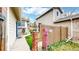 Charming walkway featuring a lamp post, decorative windmill, lush lawn, and a welcoming sign, leading to the home's entrance at 464 Chiswick Cir, Highlands Ranch, CO 80126
