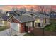 Charming home with a two-car garage, brick accents, and colorful decorations at 464 Chiswick Cir, Highlands Ranch, CO 80126