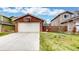 Detached red brick garage with a basketball hoop, set on a well-manicured lawn with decorative landscaping at 464 Chiswick Cir, Highlands Ranch, CO 80126