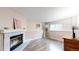 Bright living room featuring a classic fireplace and wood-look flooring at 464 Chiswick Cir, Highlands Ranch, CO 80126