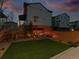 Evening view of the backyard showing firepit, lawn and patio at 4125 Coriander St, Castle Rock, CO 80109