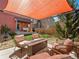 Backyard patio area with comfortable seating, fire pit, and shaded pergola at 4125 Coriander St, Castle Rock, CO 80109
