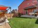 Green backyard with patio, seating, and well-maintained lawn at 4125 Coriander St, Castle Rock, CO 80109