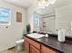 Bright bathroom featuring modern vanity, sink, and a well-lit shower at 4125 Coriander St, Castle Rock, CO 80109