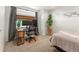 Bright bedroom with a desk, two monitors and ample light from the large window and stylish decor at 4125 Coriander St, Castle Rock, CO 80109