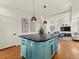 Kitchen island with seating, stylish pendant lighting, and views of the open living area at 4125 Coriander St, Castle Rock, CO 80109