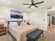 Spacious main bedroom with plush carpet, neutral walls, with a ceiling fan and stylish decor at 4125 Coriander St, Castle Rock, CO 80109