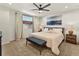 Spacious main bedroom with plush carpet, neutral walls, large window with curtains, ceiling fan and stylish decor at 4125 Coriander St, Castle Rock, CO 80109