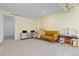 Spacious finished basement with a comfortable couch, a toy kitchen and neutral carpet at 9719 Burberry Way, Highlands Ranch, CO 80129