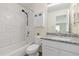 Bathroom with a tub and shower featuring marble tile and a vanity with granite countertop at 9719 Burberry Way, Highlands Ranch, CO 80129