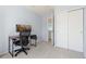 Well-lit room with a desk and good storage, featuring neutral walls and carpet at 9719 Burberry Way, Highlands Ranch, CO 80129