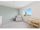 Upstairs bedroom with recliner and study desk at 9719 Burberry Way, Highlands Ranch, CO 80129