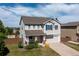 Two-story home with a two-car garage, lovely landscaping, and a charming front porch at 9719 Burberry Way, Highlands Ranch, CO 80129