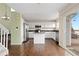 Bright kitchen features white cabinets, dark granite countertops, stainless appliances, and center island at 9719 Burberry Way, Highlands Ranch, CO 80129