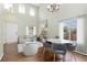 Bright living room with hardwood floors, vaulted ceilings, and a sliding glass door with backyard view at 9719 Burberry Way, Highlands Ranch, CO 80129
