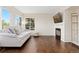 Bright living room with large windows, fireplace, and hardwood floors at 9719 Burberry Way, Highlands Ranch, CO 80129