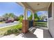 Inviting covered porch with brick supports and blue railing, offering a cozy outdoor space at 9719 Burberry Way, Highlands Ranch, CO 80129