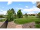 Manicured backyard featuring a well-maintained lawn, mature trees, lake view and access to a golf course at 1251 Double Eagle Ct, Castle Rock, CO 80104