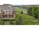 Backyard with scenic golf course and lake views, featuring a two-story patio and lush landscaping at 1251 Double Eagle Ct, Castle Rock, CO 80104
