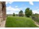 Manicured backyard with lush grass, a dark metal fence, and beautiful views at 1251 Double Eagle Ct, Castle Rock, CO 80104