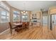 Bright dining area featuring a wooden table and chairs, complemented by natural light from large windows at 1251 Double Eagle Ct, Castle Rock, CO 80104
