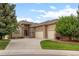 Charming home featuring a stone facade, manicured lawn, and three-car garage at 1251 Double Eagle Ct, Castle Rock, CO 80104