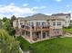 Exterior shot of the rear of the house featuring a walkout basement and second story patio with golf course views at 1251 Double Eagle Ct, Castle Rock, CO 80104