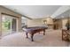 Open-concept game room with a pool table, wet bar, and access to the outdoor patio at 1251 Double Eagle Ct, Castle Rock, CO 80104