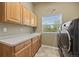 Laundry room features plenty of cabinet and counter space and modern washer and dryer at 1251 Double Eagle Ct, Castle Rock, CO 80104