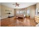 Bright main bedroom with a unique wooden bed frame, ample natural light, and hardwood flooring at 1251 Double Eagle Ct, Castle Rock, CO 80104