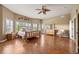 Spacious main bedroom with a wooden bed frame, hardwood floors, and an abundance of natural light from multiple windows at 1251 Double Eagle Ct, Castle Rock, CO 80104
