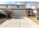 Two-story townhome featuring a private garage, a driveway and mature landscaping at 4042 E Geddes Cir, Centennial, CO 80122