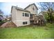 Exterior view of the back of the house featuring a spacious yard and deck at 329 Lodgewood Ln, Lafayette, CO 80026