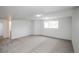 Large basement featuring neutral carpet, ample space, and a window with natural light at 329 Lodgewood Ln, Lafayette, CO 80026
