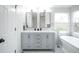 A stylish bathroom features a double vanity, a soaking tub, and modern fixtures at 329 Lodgewood Ln, Lafayette, CO 80026
